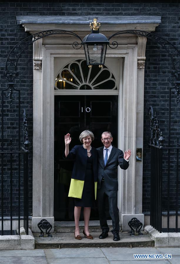 Britain's new Prime Minister Theresa May(L) and her husband pose for photos in front of 10 Downing Street in London, Britain on July 13, 2016. Britain's new Prime Minister Theresa May(L) and her husband pose for photos in front of 10 Downing Street in London, Britain on July 13, 2016.