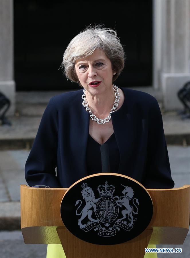 Britain's new Prime Minister Theresa May(L) and her husband pose for photos in front of 10 Downing Street in London, Britain on July 13, 2016. Britain's new Prime Minister Theresa May(L) and her husband pose for photos in front of 10 Downing Street in London, Britain on July 13, 2016.