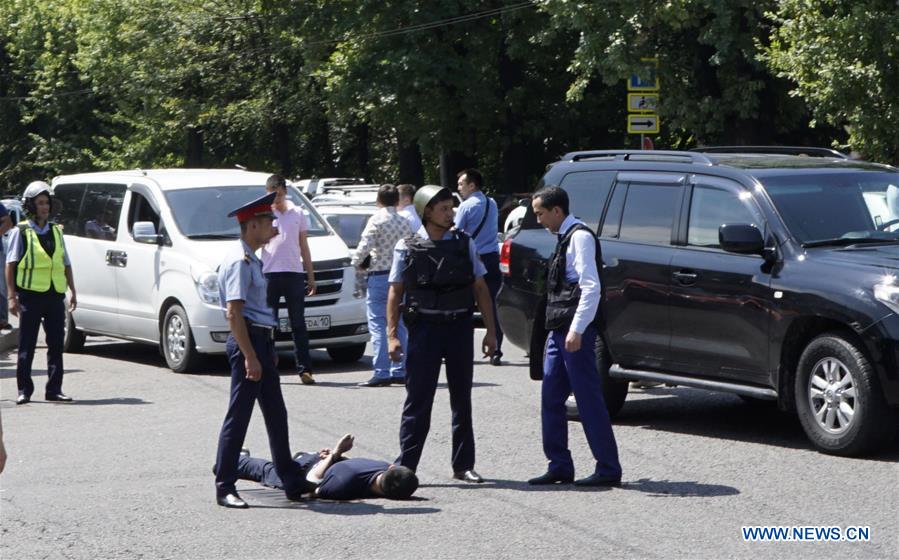 Police officers detain a man at a scene of shooting on the street in Almaty, Kazakhstan, July 18, 2016. Police officers detain a man at a scene of shooting on the street in Almaty, Kazakhstan, July 18, 2016.