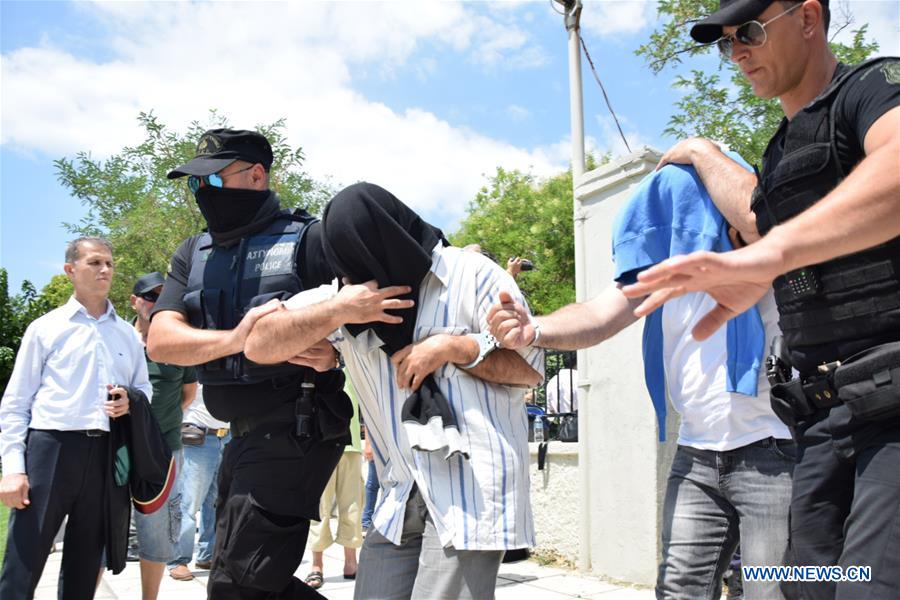 Policemen escort Turkish military officers, who fled to Greece in a military helicopter on Saturday after the failed coup in Turkey, out of a court in Alexandroupolis, Greece, on July 18, 2016 Policemen escort Turkish military officers, who fled to Greece in a military helicopter on Saturday after the failed coup in Turkey, out of a court in Alexandroupolis, Greece, on July 18, 2016