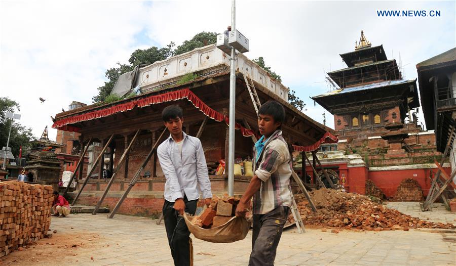 Workers carry bricks at a reconstruction site of a damaged temple at Hanumandhoka Durbar Square, a UNESCO heritage site in Kathmandu, Nepal, July 20, 2016. Workers carry bricks at a reconstruction site of a damaged temple at Hanumandhoka Durbar Square, a UNESCO heritage site in Kathmandu, Nepal, July 20, 2016.