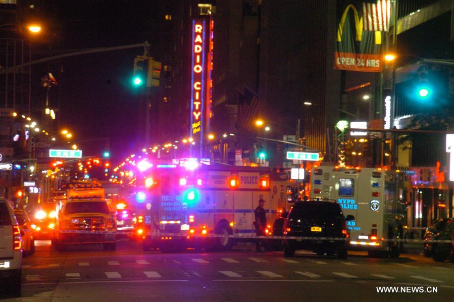 A man tossed a hoax explosive into a marked police car in midtown Manhattan on Wednesday night and was taken into custody at Columbus Circle on Thursday morning.