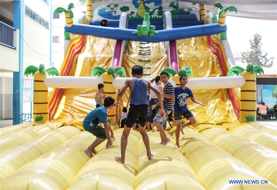 Palestinian children play at the summer camp organized by the UNRWA in Gaza City, on July 25, 2016.