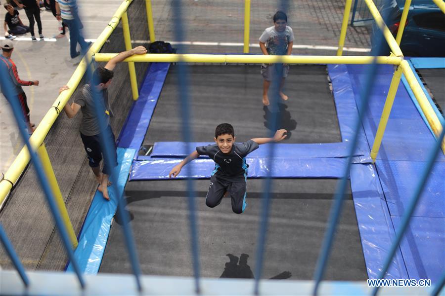 Palestinian children play at the summer camp organized by the UNRWA in Gaza City, on July 25, 2016.
