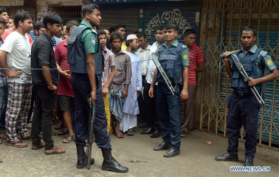 Policemen stand guard at the site where nine suspected militants were killed in Dhaka, Bangladesh, on July 26, 2016. 