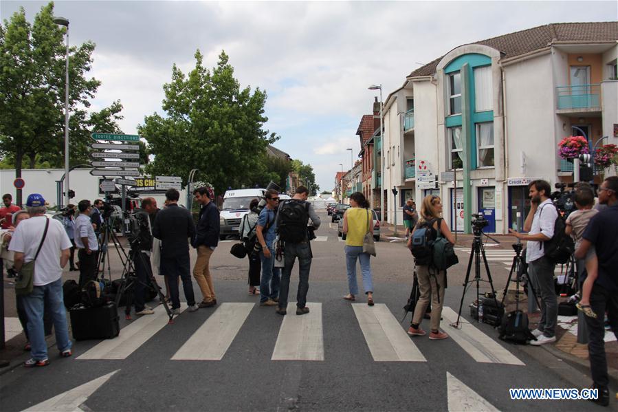 Police stand guard near the church where a priest was killed in Saint-Etienne du Rouvray, France on July 26, 2016.