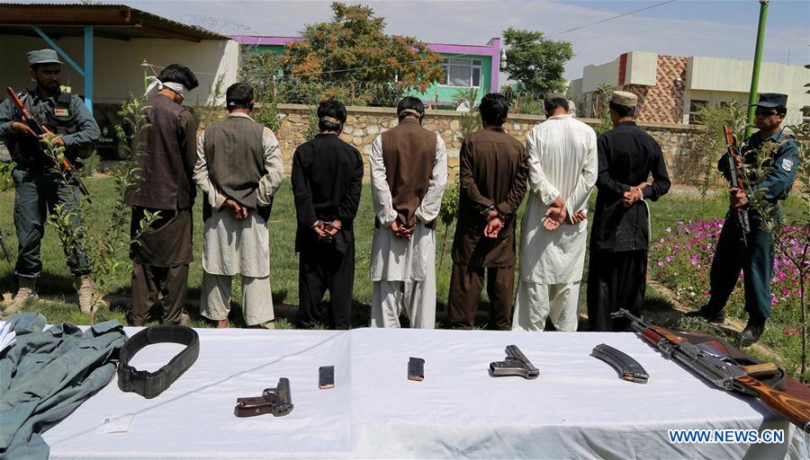 Suspected Taliban militants stand handcuffed behind weapons placed on tables in Ghazni province, Afghanistan, on July 27, 2016. Suspected Taliban militants stand handcuffed behind weapons placed on tables in Ghazni province, Afghanistan, on July 27, 2016.
