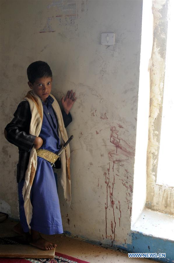 People inspect the mosque attacked by a gunman in Yemen's capital of Sanaa on July 27, 2016.