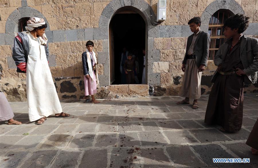 People inspect the mosque attacked by a gunman in Yemen's capital of Sanaa on July 27, 2016.