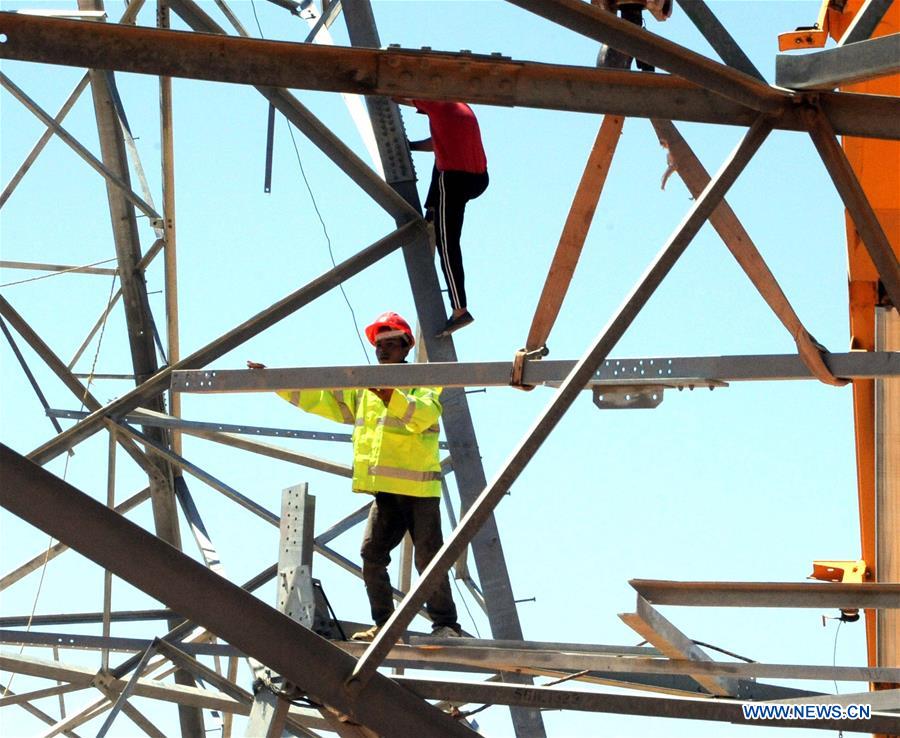 Electricity workers fix high-voltage power lines in Dimas, countryside of Damascus, capital of Syria, on July 27, 2016.