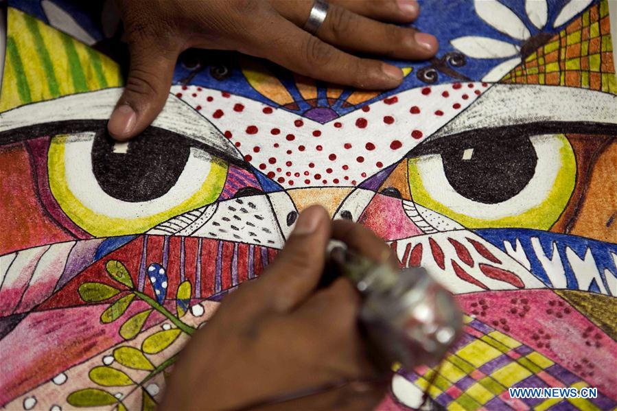 A woman picks up one of the leather goods made by inmates from Mexican prisons at a store in Mexico City, capital of Mexico on July 26, 2016.
