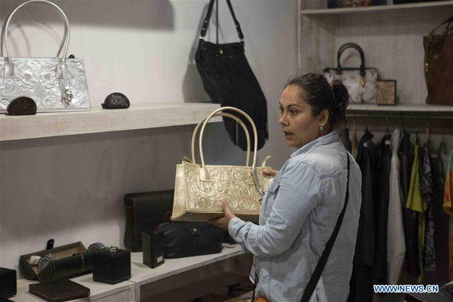 A woman picks up one of the leather goods made by inmates from Mexican prisons at a store in Mexico City, capital of Mexico on July 26, 2016. A woman picks up one of the leather goods made by inmates from Mexican prisons at a store in Mexico City, capital of Mexico on July 26, 2016.