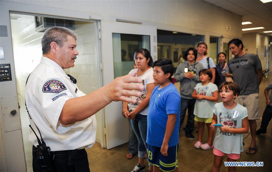 People take part in the 33rd 'National Night Out' program at the Alhambra Police Department in Los Angeles, the United States, Aug. 2, 2016. People take part in the 33rd 'National Night Out' program at the Alhambra Police Department in Los Angeles, the United States, Aug. 2, 2016.