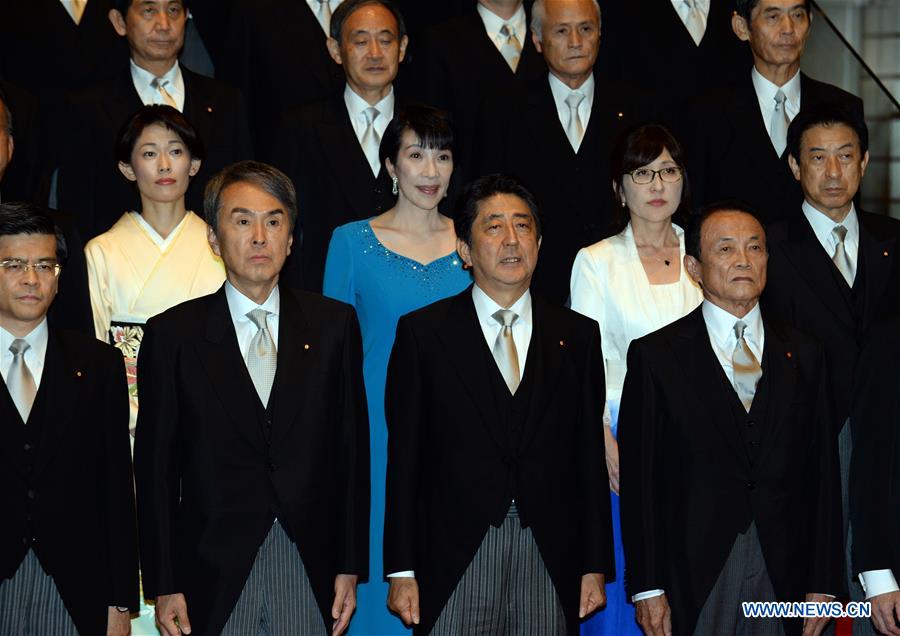 Japanese Prime Minister Shinzo Abe (C, Front) and cabinet ministers pose during a photo session at Abe's official residence in Tokyo, capital of Japan, on Aug. 3, 2016. 