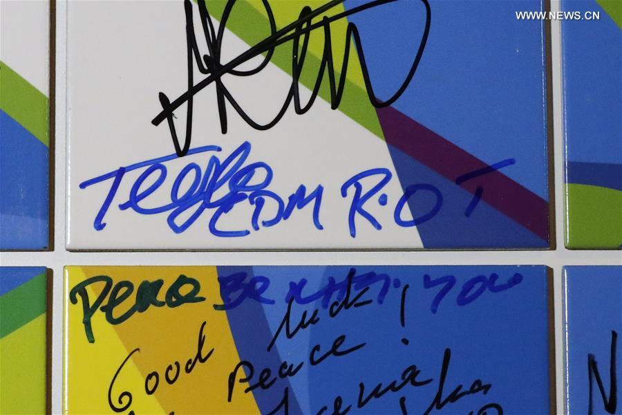 Photo taken on Aug. 3 2016 shows the signatures of the delegation of Refugee Olympics Team on the Olympic Truce Wall at the Olympic Village in Rio de Janeiro, Brazil.