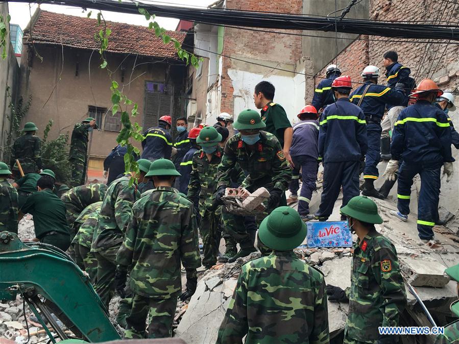 Rescuers work at the building collapse site in Hanoi, capital of Vietnam, on Aug. 4, 2016. 