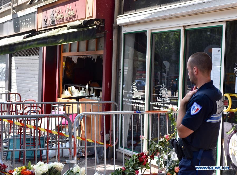 Policemen investigate the site of a bar fire in Rouen, France, on Aug. 6, 2016. 