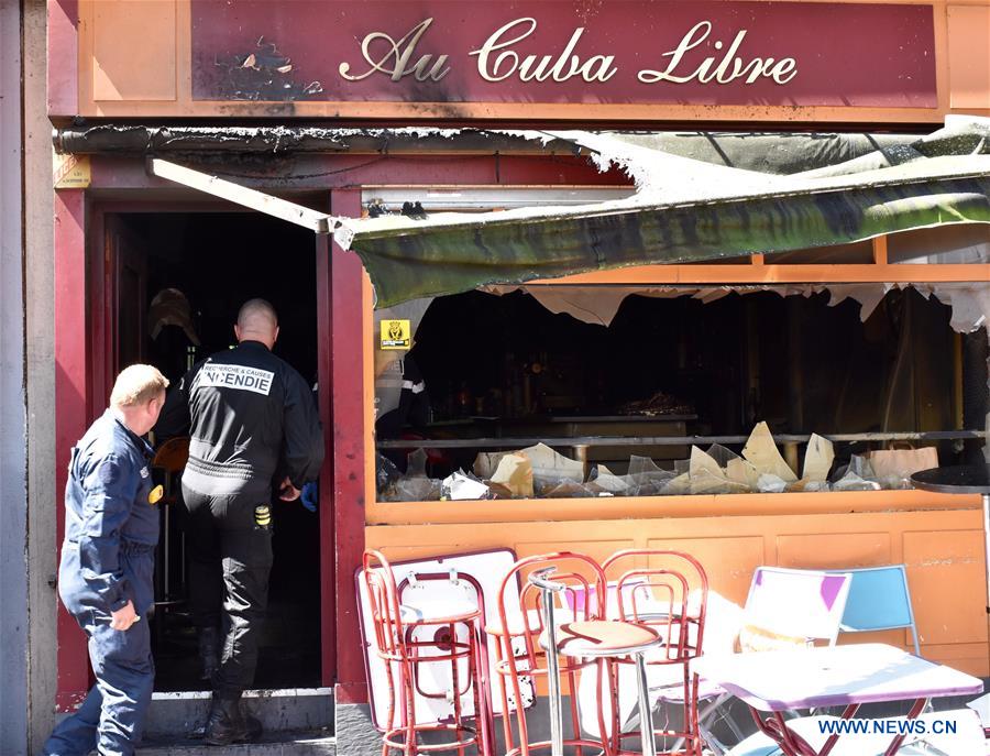 Policemen investigate the site of a bar fire in Rouen, France, on Aug. 6, 2016. 