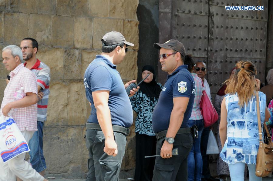 Policemen patrol in the old city of Tunis, capital of Tunisia, on Aug. 6, 2016. 