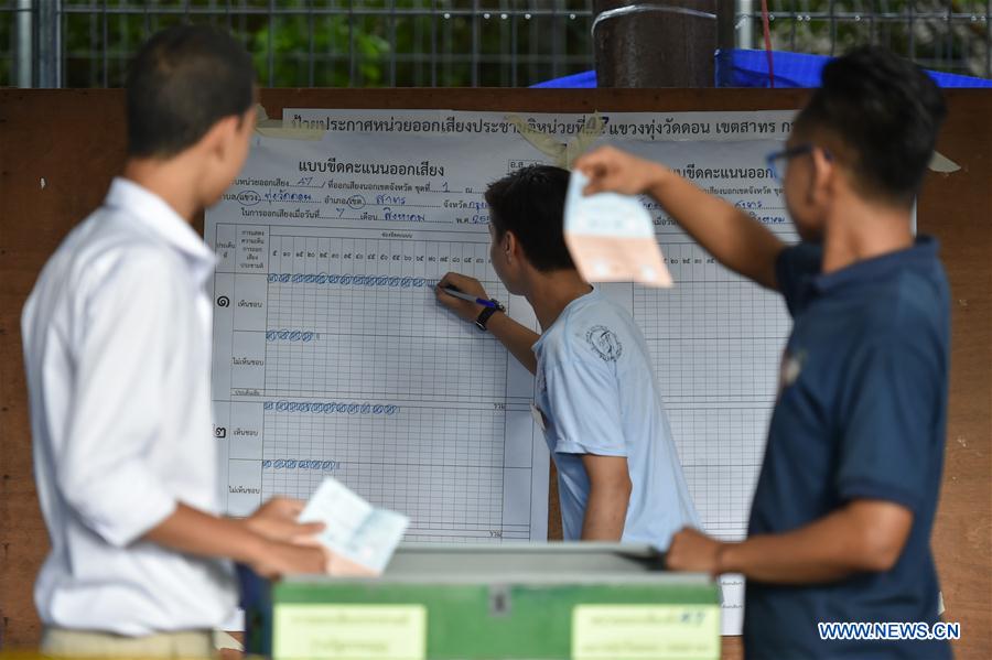 Staff members seal a ballot box at a polling station when Thailand's constitutional referendum ends in downtown Bangkok, Thailand, on Aug. 7, 2016