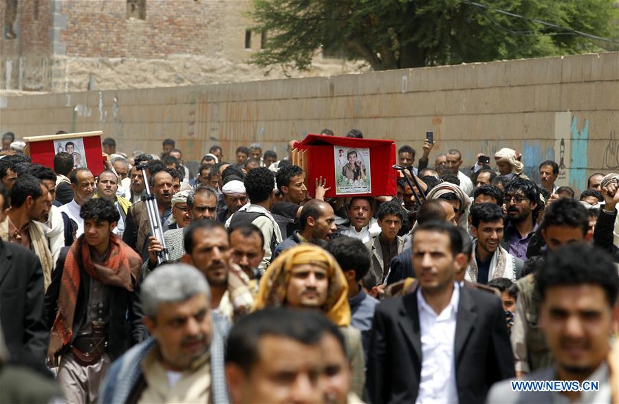A man walks among graves of Houthi fighters killed in airstrikes by the Saudi Arabia-led coalition, at a cemetry in Sanaa, capital of Yemen, on Aug. 7, 2016.