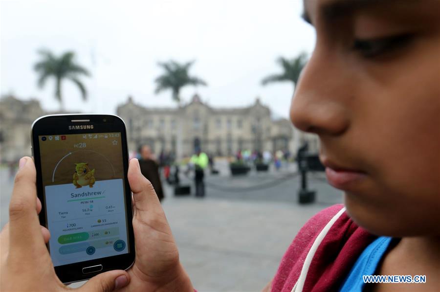 Two youngsters play 'Pokemon Go' on their smartphones at Plaza Mayor in Lima, capital of Peru, on Aug. 7, 2016. Two youngsters play 'Pokemon Go' on their smartphones at Plaza Mayor in Lima, capital of Peru, on Aug. 7, 2016.