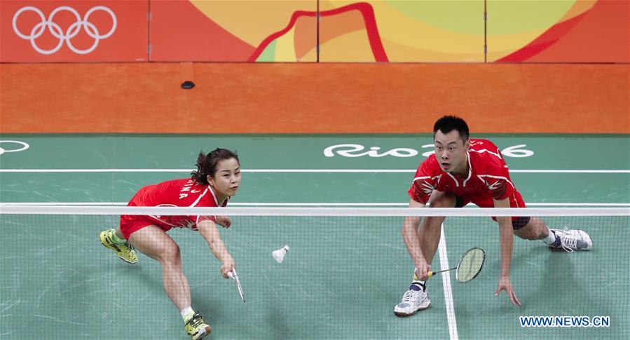 China's Xu Chen (L) and Ma Jin react during a mixed doubles group play stage match of Badminton against Denmark's Joachim Fischer Nielsen and Christinna Pedersen at the 2016 Rio Olympic Games in Rio de Janeiro, Brazil, on Aug. 13, 2016. 