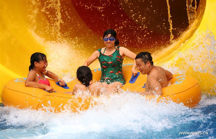 Local residents have a good time in an aqua park amid hot weather in Luzhou, southwest China's Sichuan Province, Aug. 13, 2016. 