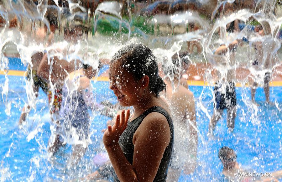 Local residents have a good time in an aqua park amid hot weather in Luzhou, southwest China's Sichuan Province, Aug. 13, 2016. 