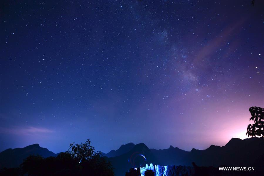 Photo taken on Aug. 25, 2016 shows starry sky in Jiulong Waterfall Scenic Spot of Luoping, southwest China's Yunnan Province.