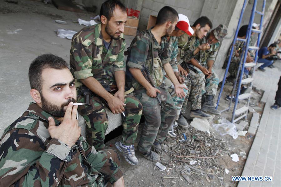 SYRIA-DARAYA-REBELS' EVACUATION-SYRIAN SOLDIERS-FEATURE