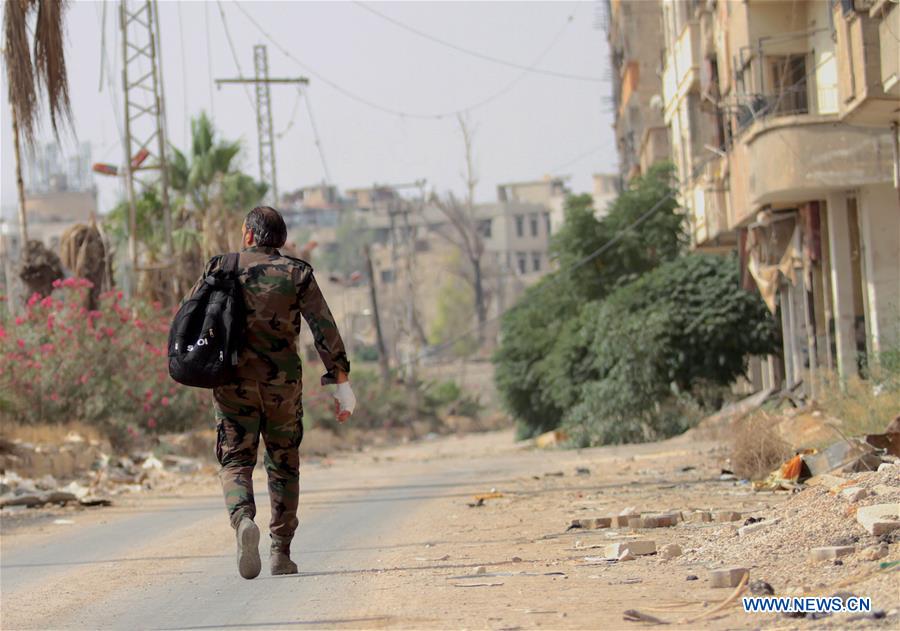 SYRIA-DARAYA-REBELS' EVACUATION-SYRIAN SOLDIERS-FEATURE