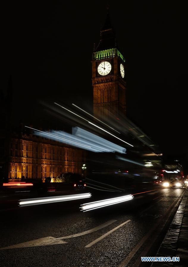A bus passes by the Elizabeth Tower (Big Ben) in central London, Britain, on Sept. 15, 2016.