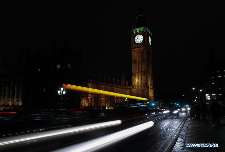A taxi passes by the Elizabeth Tower (Big Ben) in central London, Britain, on Sept. 15, 2016.