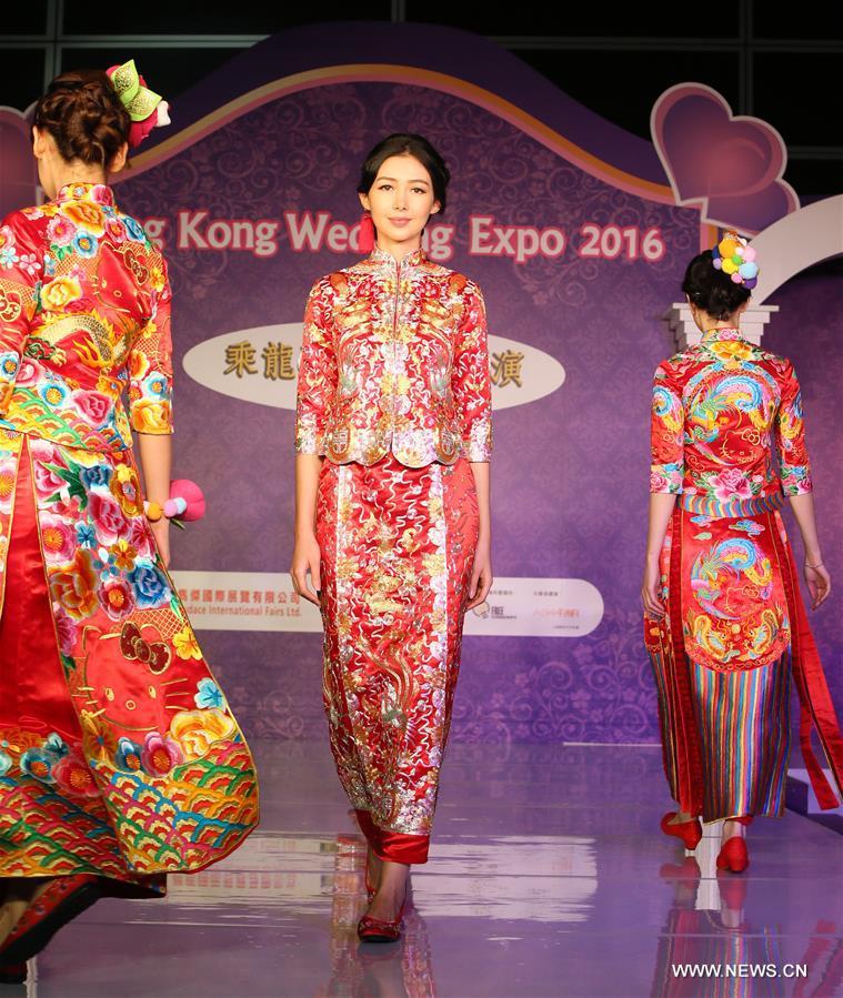 Models present Chinese traditional wedding dresses at Hong Kong Wedding Expo 2016 in Hong Kong, south China, Nov. 5, 2016. 