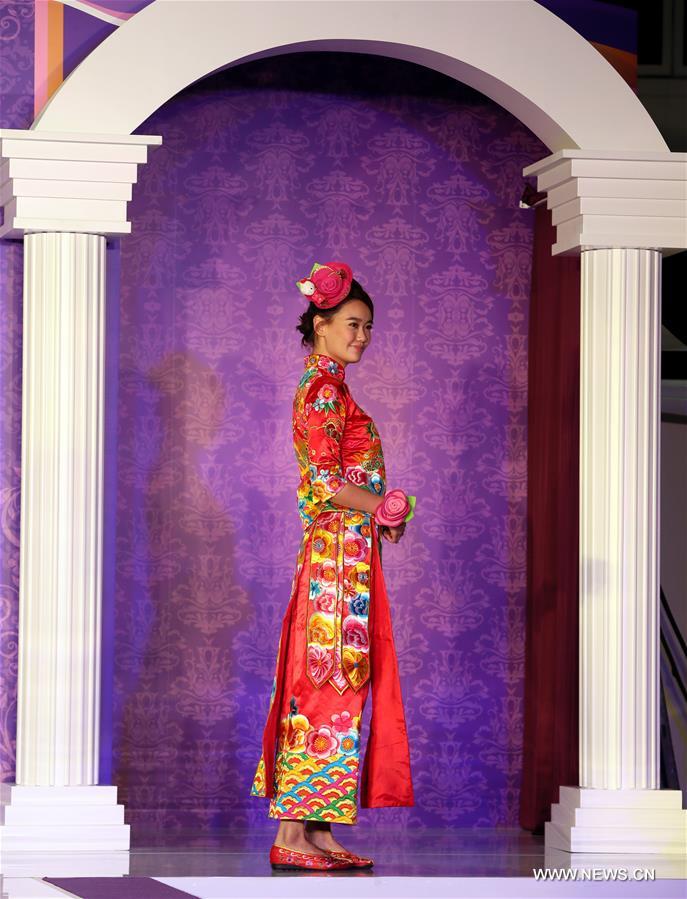 Models present Chinese traditional wedding dresses at Hong Kong Wedding Expo 2016 in Hong Kong, south China, Nov. 5, 2016. 