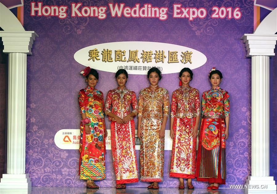 Models present Chinese traditional wedding dresses at Hong Kong Wedding Expo 2016 in Hong Kong, south China, Nov. 5, 2016. 