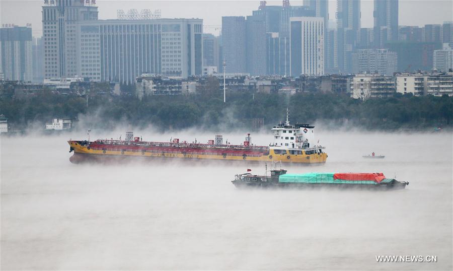 Ships sail in fog on the Yangtze River in Wuhan, capital of central China's Hubei Province, Nov. 23, 2016.