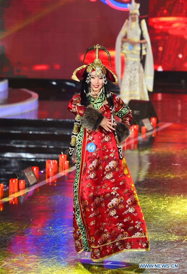 A contestant from Mongolia presents traditional costume at the China, Russia and Mongolia Beautiful Angels of International Competition in Manzhouli, north China's Inner Mongolia Autonomous Region, Dec. 23, 2016. A total of 60 contestants participated in the pageant's final. (Xinhua/Deng Hua) 