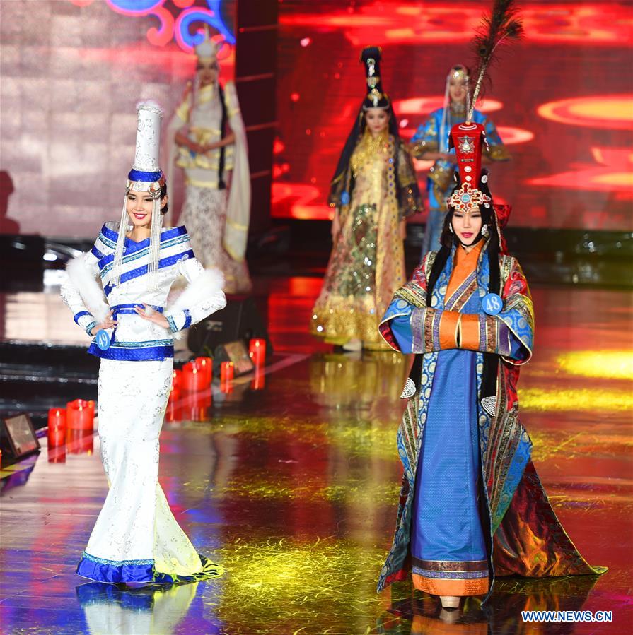 Contestants from Mongolia present traditional costumes at the China, Russia and Mongolia Beautiful Angels of International Competition in Manzhouli, north China's Inner Mongolia Autonomous Region, Dec. 23, 2016. A total of 60 contestants participated in the pageant's final. (Xinhua/Deng Hua) 
