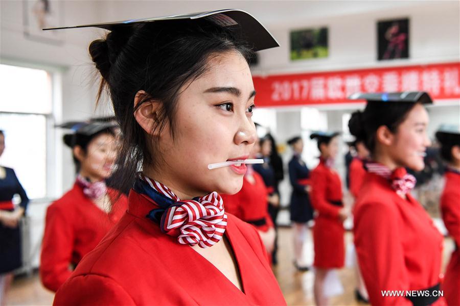 Students attend a stewardess skill training for the upcoming 2017 entrance examination for art majors in colleges in Luoyang, central China's Henan Province, Jan. 4, 2017.