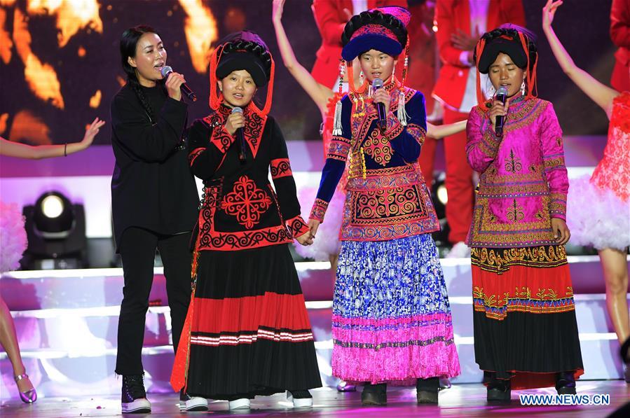 Pop singer Na Ying (1st L) sings with three girls who were once the students of Asur, a winner of the Jack Ma Rural Teachers Award, during the awarding ceremony in Sanya, a tourism resort in south China's Hainan Province, on Jan. 5, 2017. The awarding ceremony of the Jack Ma Rural Teachers Award was held on Thursday, with 100 rural teachers winning the award of 100,000 yuan (14,522 U.S. dollars) respectively. (Xinhua/Yang Guanyu) 