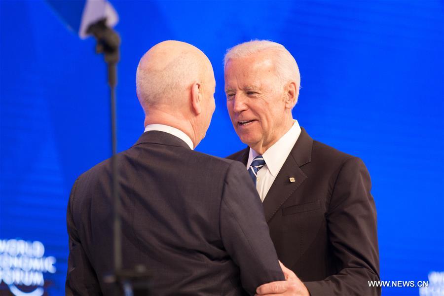 Klaus Schwab (L), Founder and Executive Chairman of World Economic Forum (WEF), welcomes Joe Biden, vice president of the United States at the annual meeting of the WEF in Davos, Switzerland, Jan. 18, 2017. (Xinhua/Xu Jinquan)