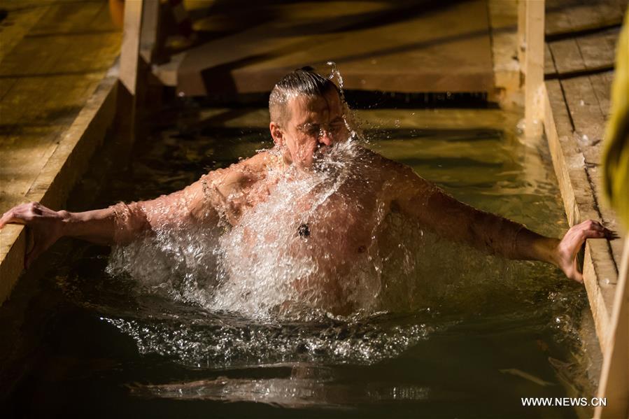 A man takes a dip in icy water during the Orthodox Epiphany celebrations in Moscow, Russia, on Jan. 18, 2017. 