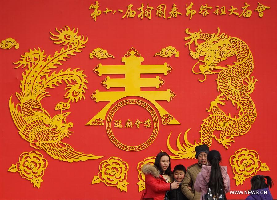 Tourists visit a temple fair in Kaifeng, central China's Henan Province, Jan. 31, 2017.