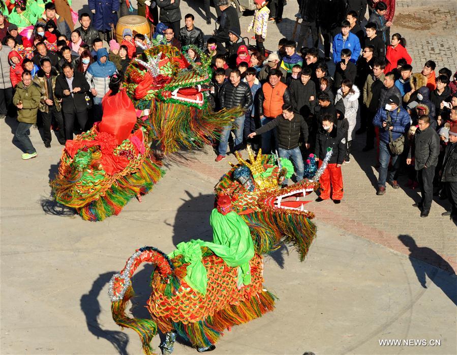 Folk artists perform kylin (a mythical creature in Chinese legend) dance to greet the upcoming Lantern Festival in Huanghua, north China's Hebei Province, Feb. 9, 2017. 