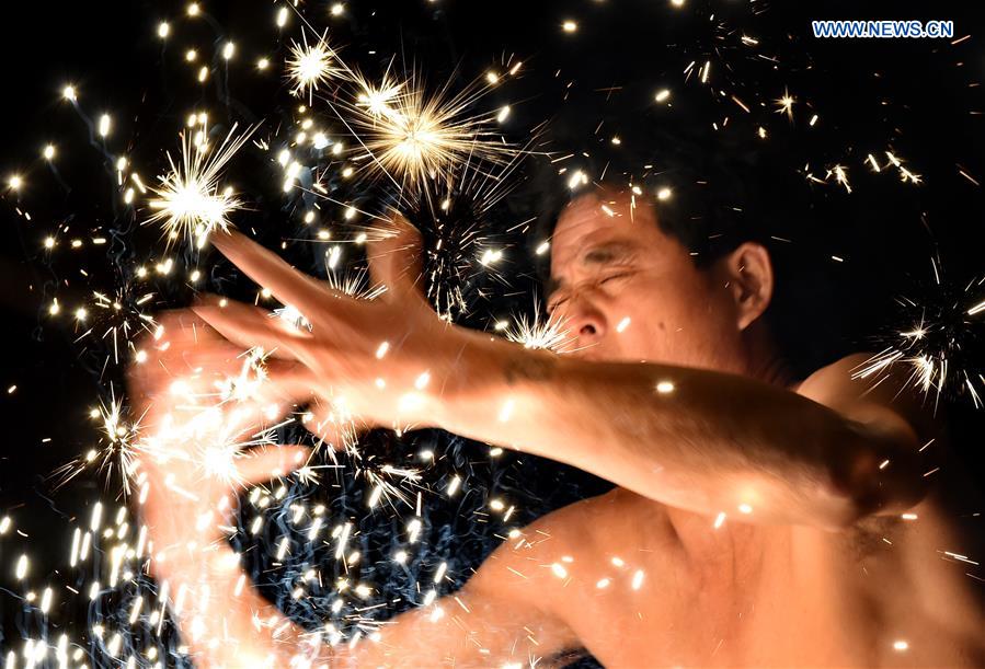 A villager performs 'firework eating' in Huadong Village, Putian City of southeast China's Fujian Province, Feb. 12, 2017. A villager performs 'firework eating' in Huadong Village, Putian City of southeast China's Fujian Province, Feb. 12, 2017.