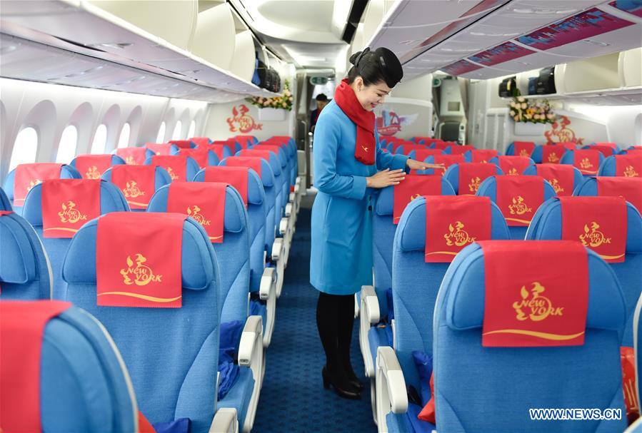 A stewardess arranges seats on the flight MF849 before passengers' boarding at the Fuzhou International Airport in Fuzhou, capital of southeast China's Fujian Province, Feb. 15, 2017. MF849, the first direct flight of Xiamen Airlines from Fuzhou to New York, took off here on Wednesday. 