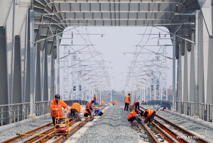 Workers adjust Wuhan-Jiujiang Passenger Railway in Jiujiang, east China's Jiangxi Province, Feb. 15, 2017.