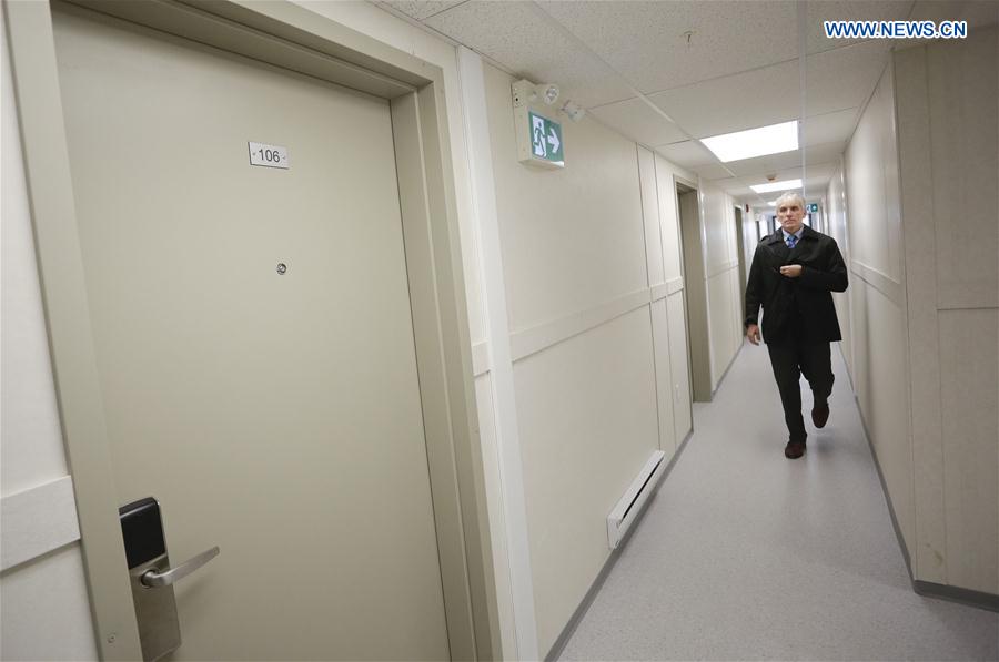 A visitor walks along the corridor that connecting the modular house unit in Vancouver, Canada, Feb. 16, 2017. 